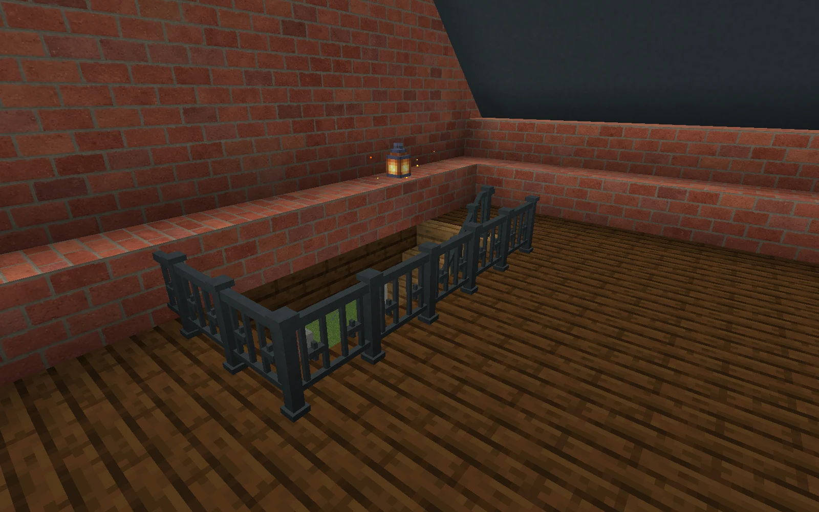 An iron guard surrounds a loft stair opening, beside a continuous brick lining and a lantern.