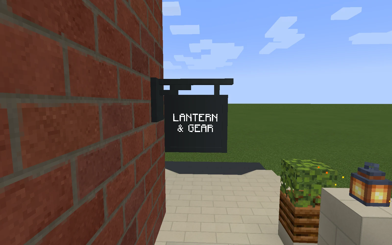 White Lantern & Gear lettering sits within the moulded edge of a charcoal timber board hanging from a stepped iron bracket.