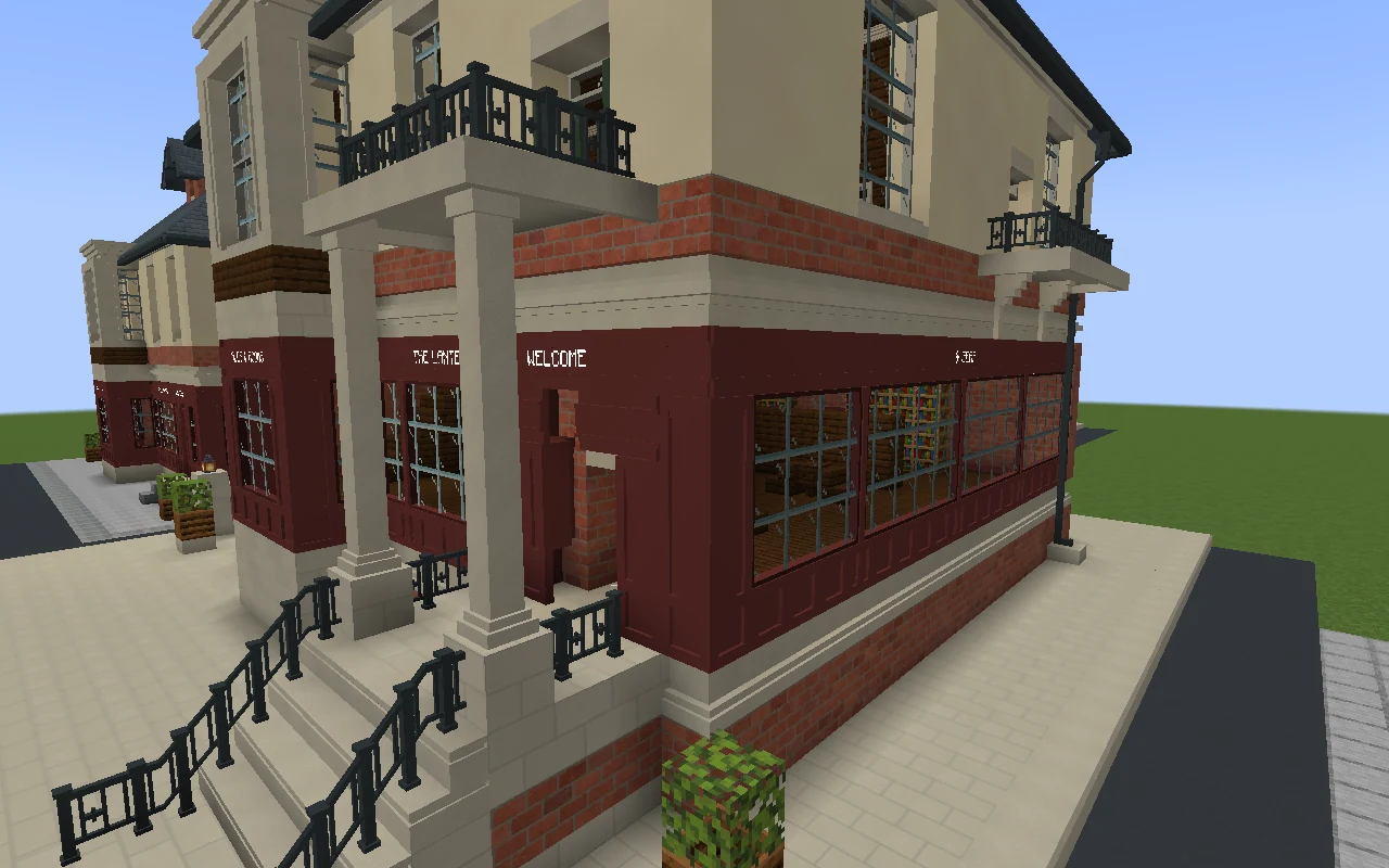 The oxblood corner shopfront of the Lantern and Gear pub, with continuous fascia boards and solid panels beneath its glazed windows.