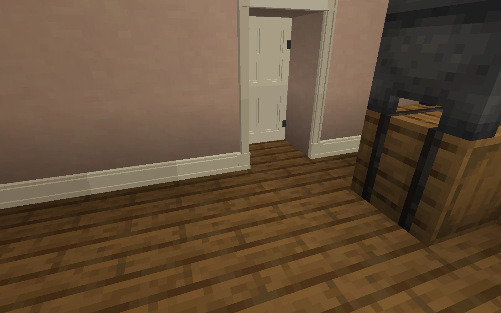 Close view of fitted ivory skirting meeting the feet of a door casing with the threshold left clear.